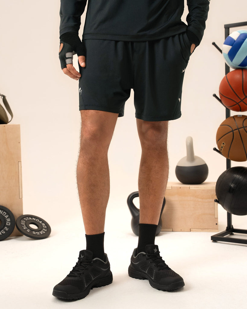 Man training weights in black 2-in-1 gym shorts