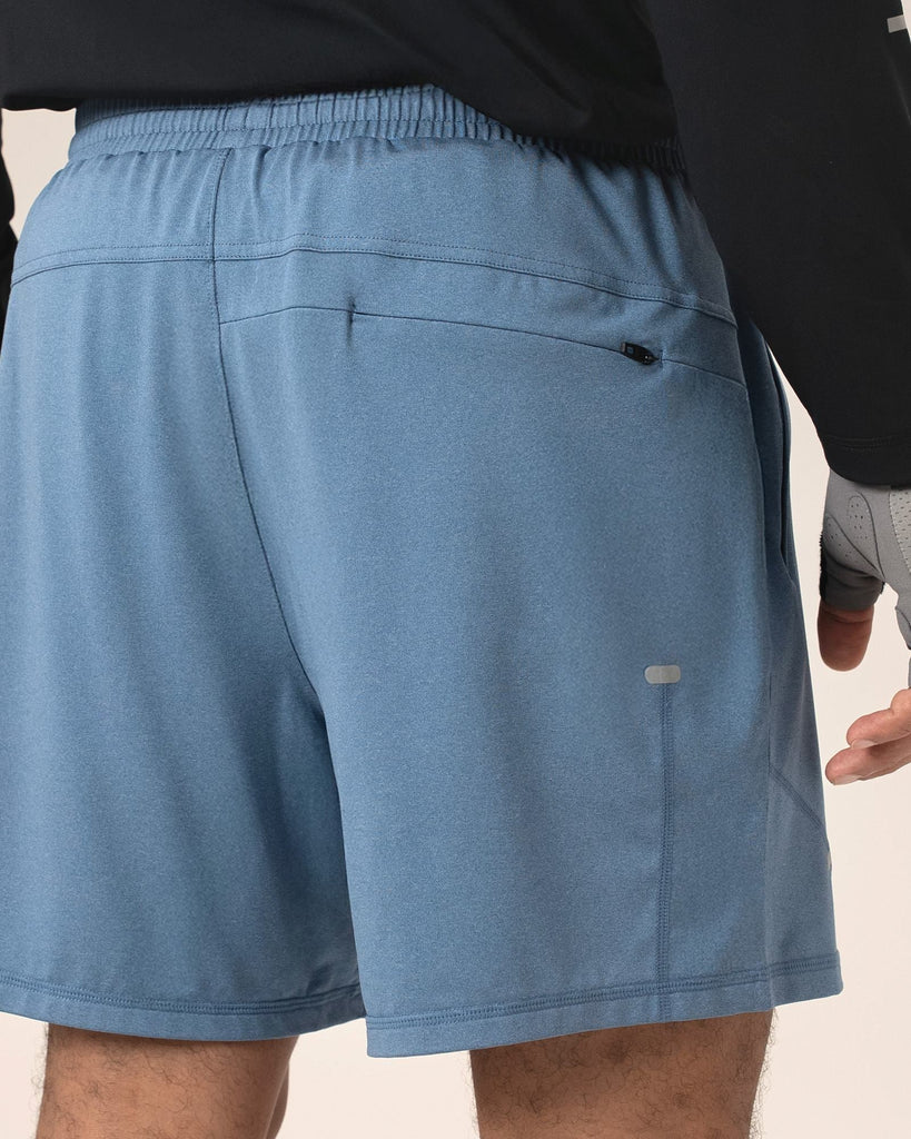 Rear view showing seams and cut of blue recycled running shorts