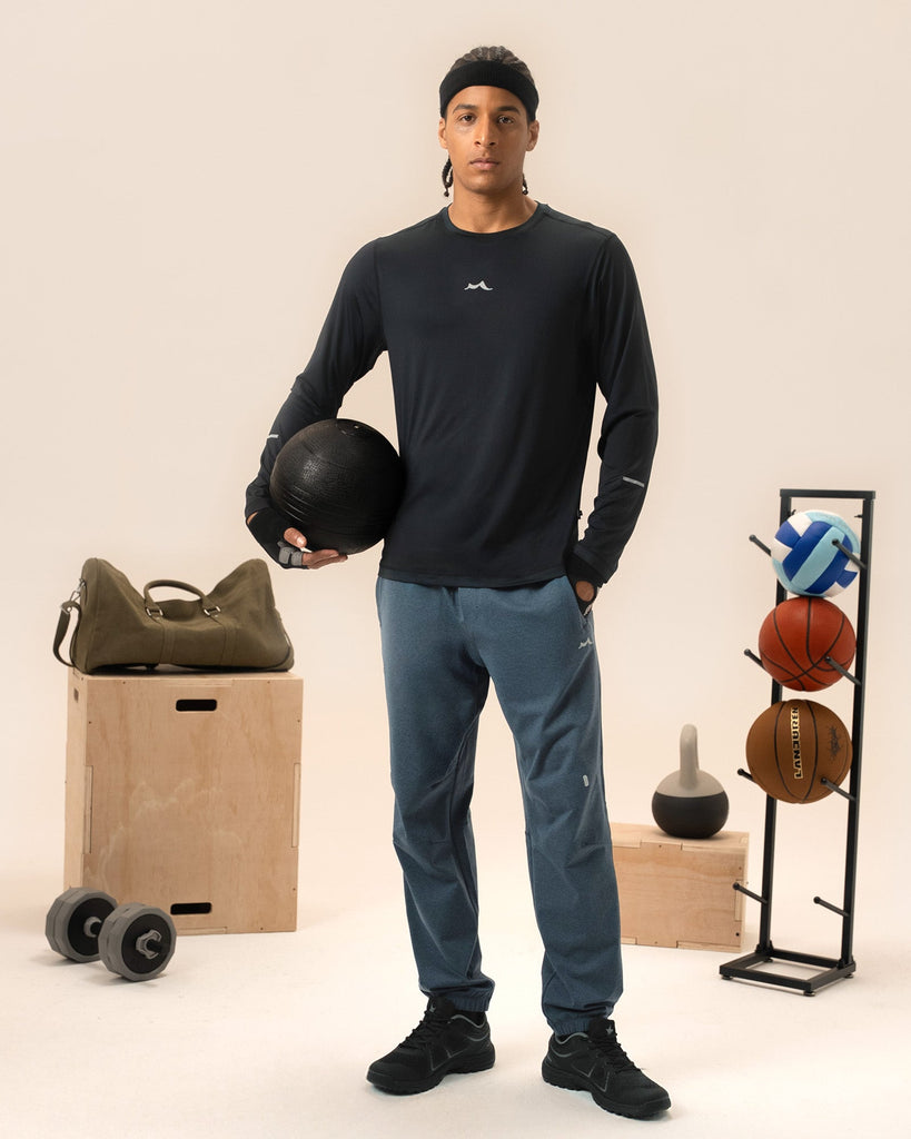 Man stretching in navy blue joggers before morning workout