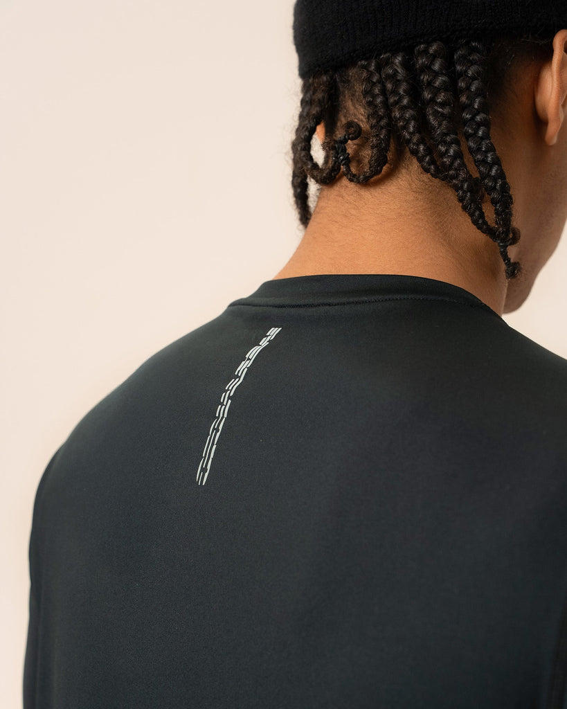 Back view showing athletic fit and yoke seam of black long sleeve shirt