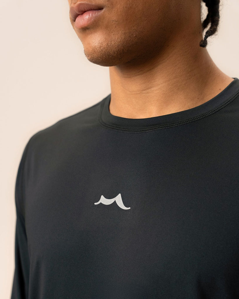 Back view showing athletic fit and yoke seam of black long sleeve shirt