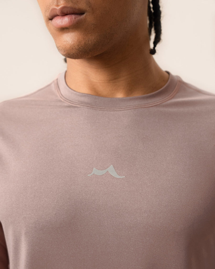 Close-up of the breathable knit pattern on dusty rose performance top